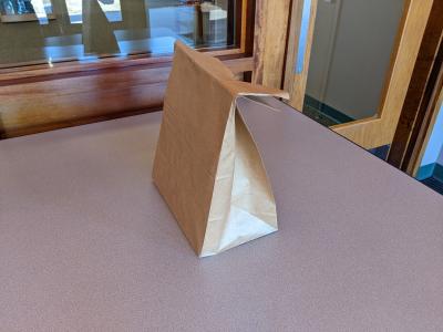 Paper shopping bag on table